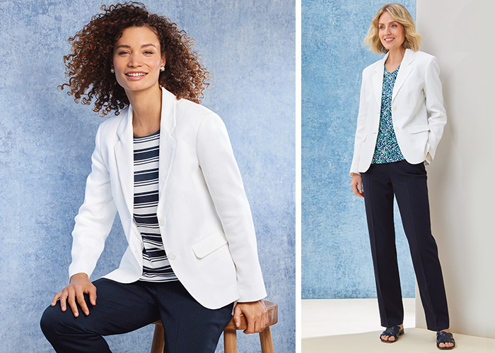 two models wearing a white textured summer blazer, designed for a mature lady. Both are wearing a jersey top and a pair of navy blue trousers. 