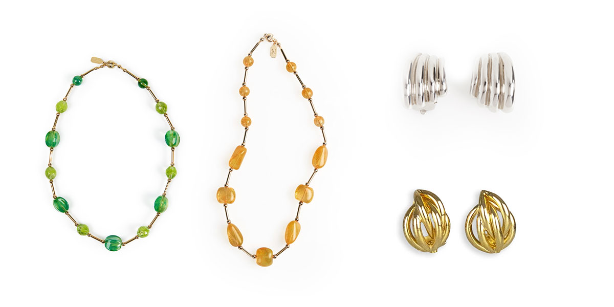 a display of green and yellow Venetian glass necklaces and a pair of both gold and silver Italian clip earrings. 